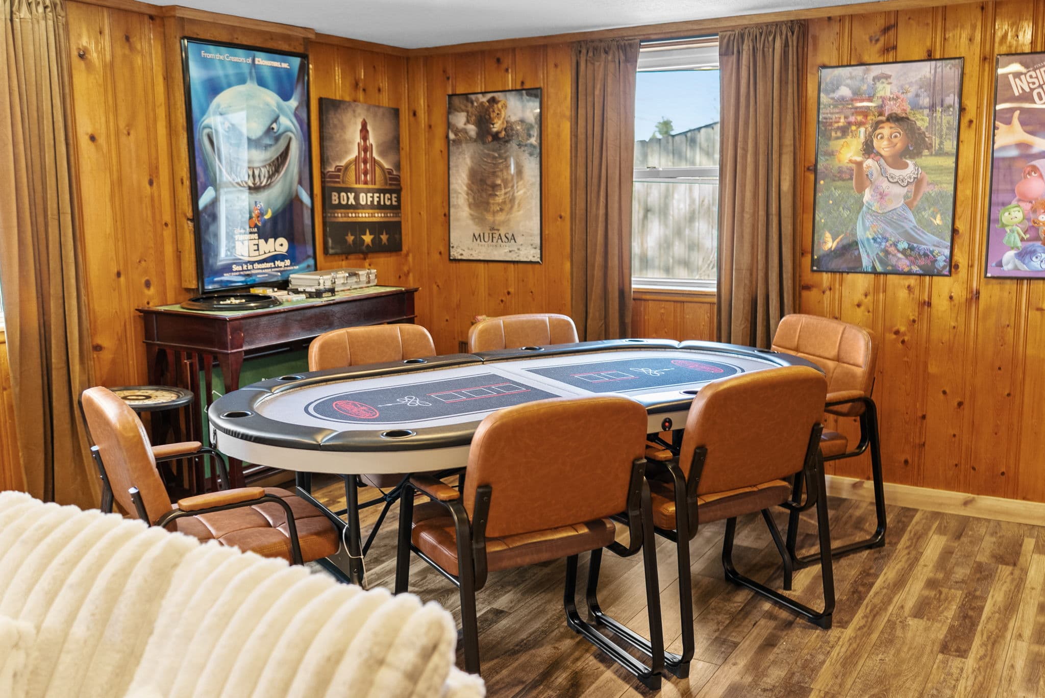 Poker table framed by movie posters