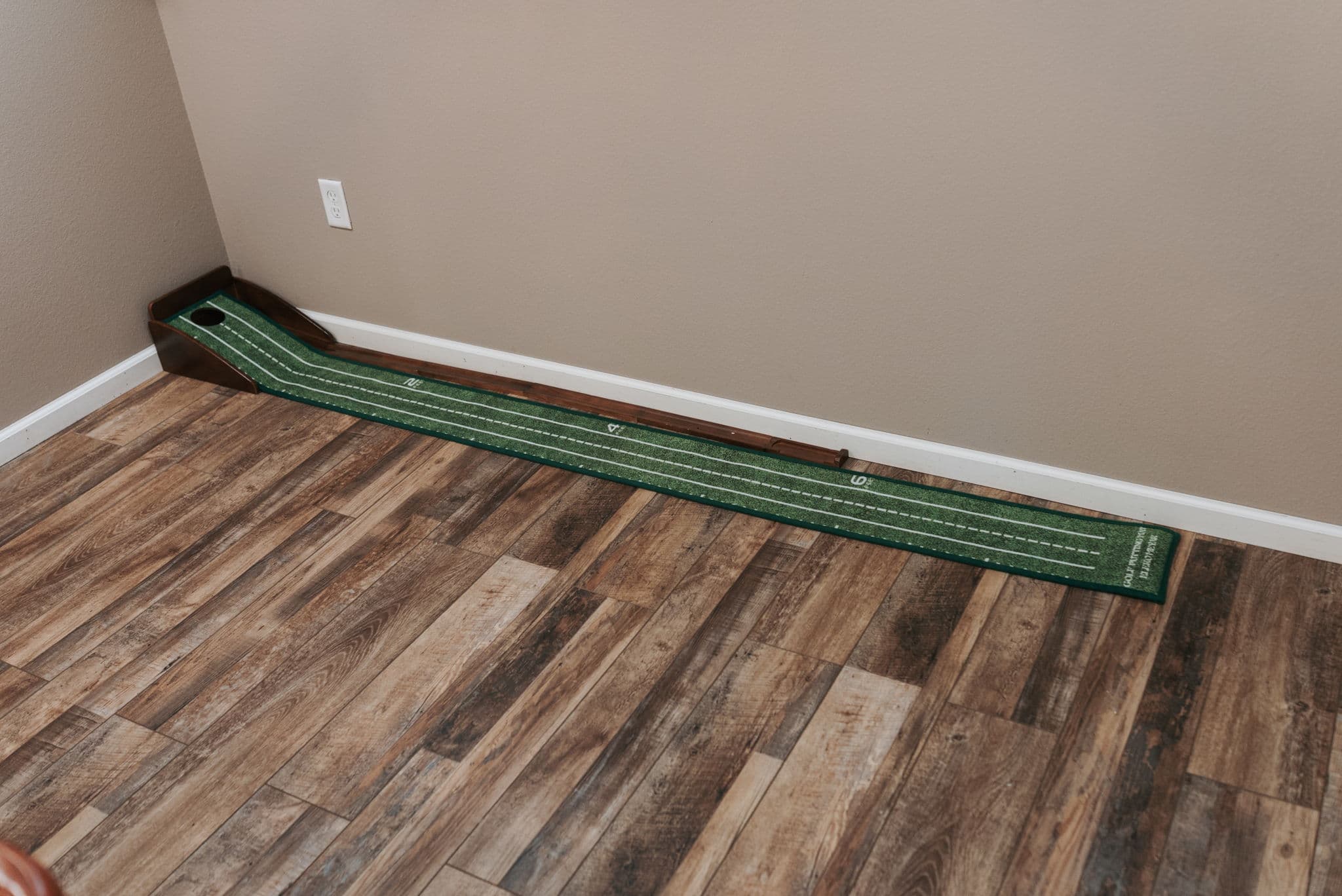 Indoor putting green on a hardwood floor